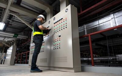 Electrical Engineer team working front HVAC control panels, Technician daily check controls system for security functions in service room at factory. Heating,Ventilation,Air Conditioning.