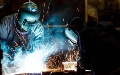 worker with protective mask welding metal